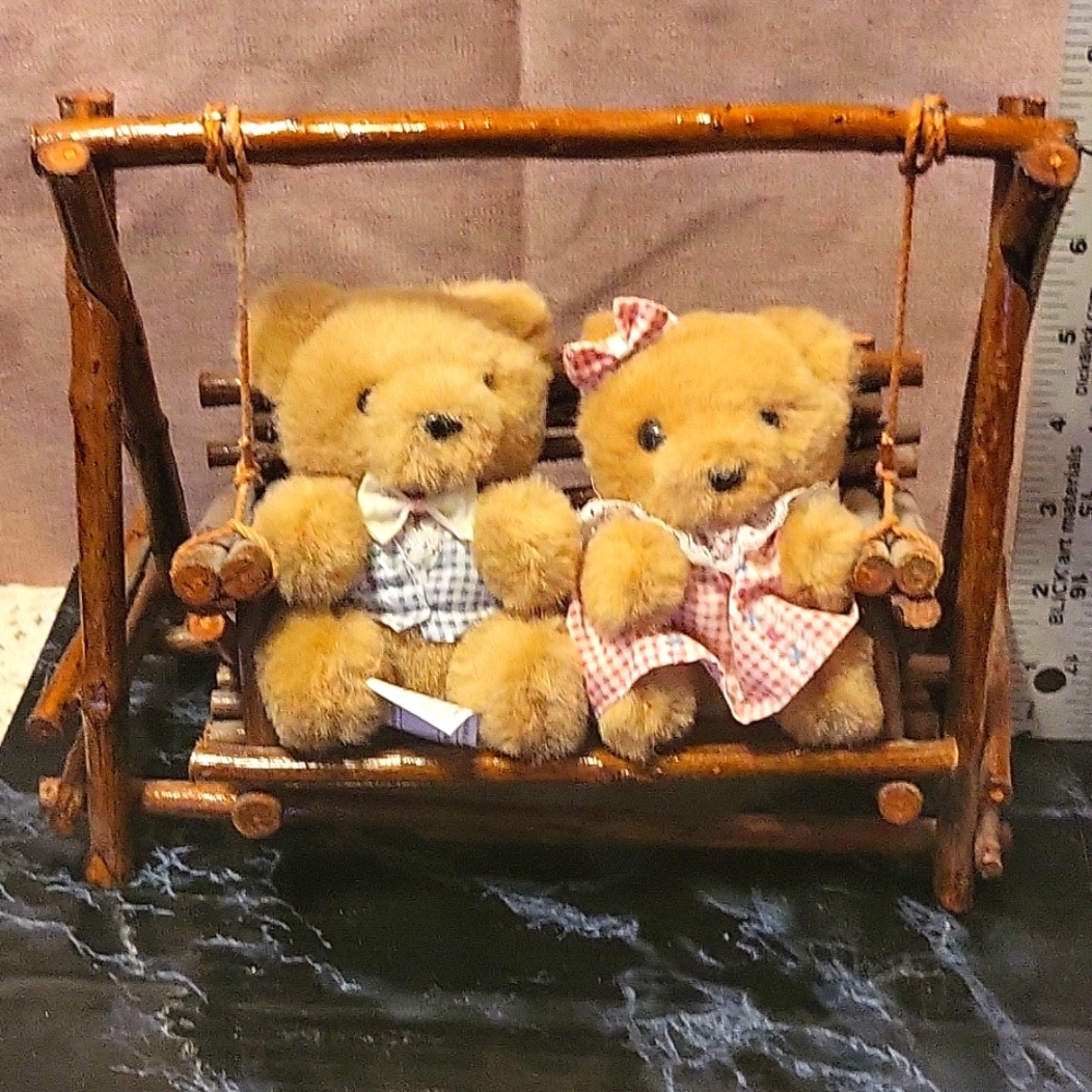 Vintage teddy bear couple on wooden swing